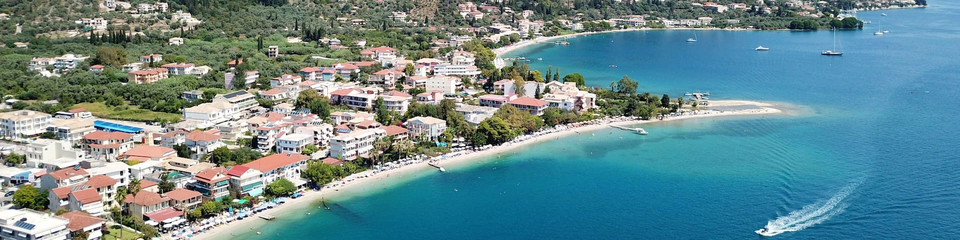 Aerial drone bird's eye view photo of iconic port of Nidri or Nydri a safe harbor for sail boats and famous for trips to Meganisi, Skorpios and other Ionian islands, Leflkada island, Ionian, Greece