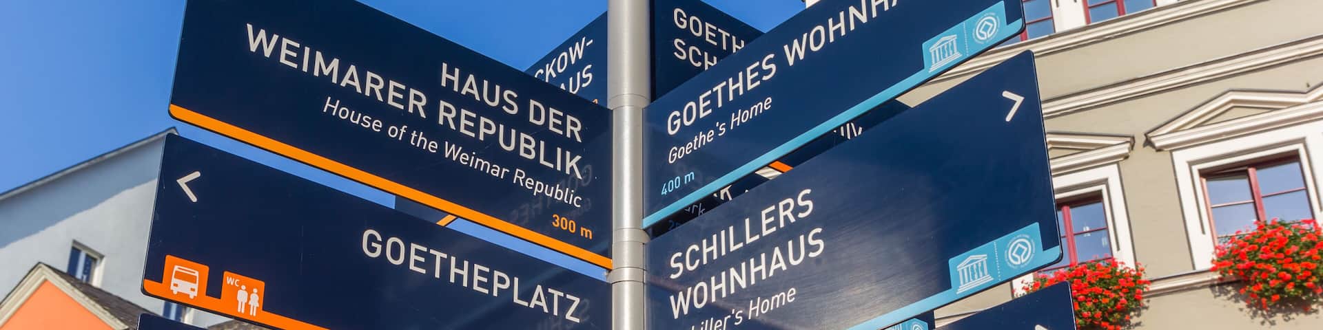 Tourist information sign in front of a historic building in Weimar, Germany