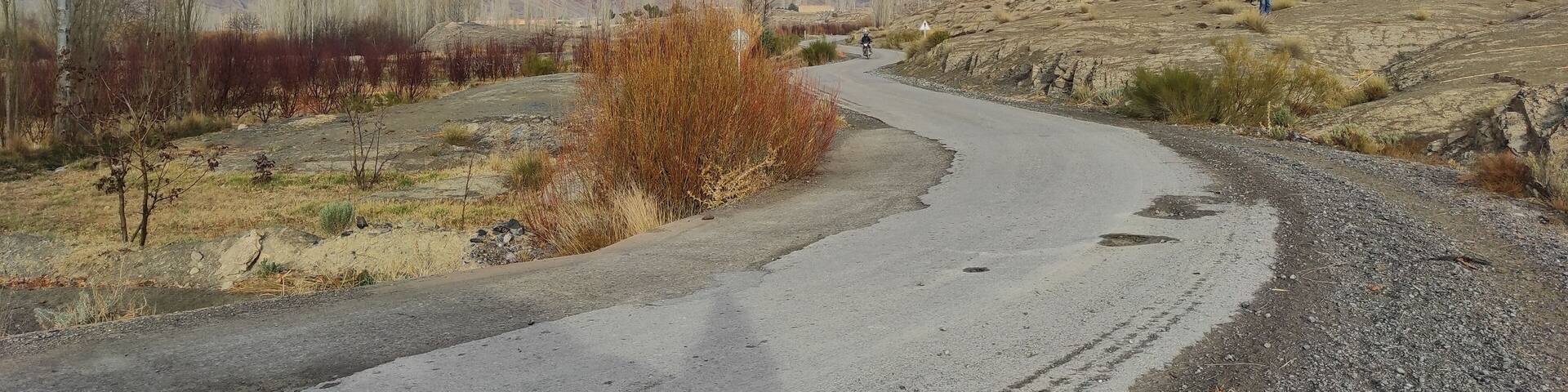Panoramic view of a road heading to the gray mountains under the clear sky in Morocco