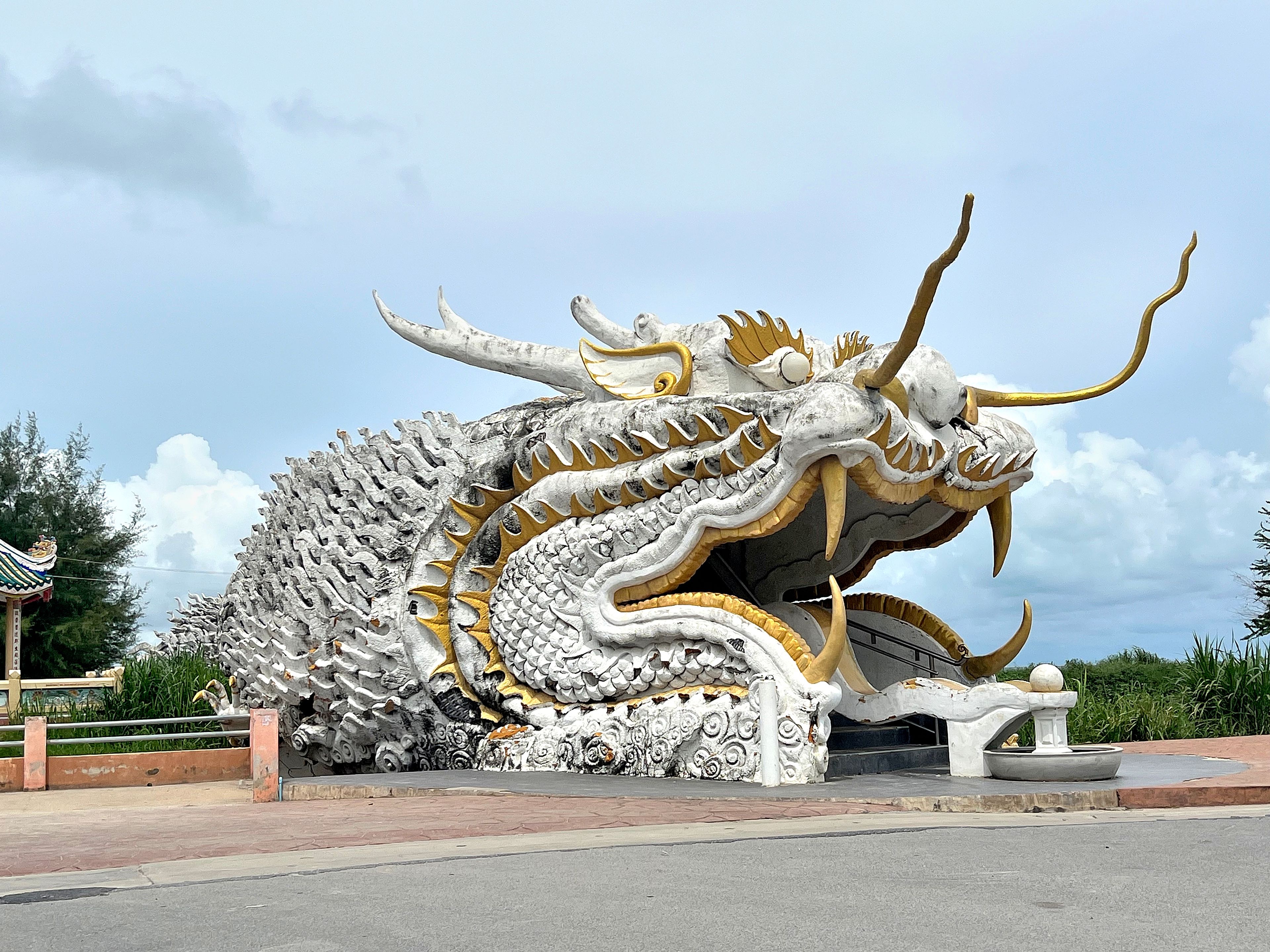 A large dragon statue with intricate details and golden accents.