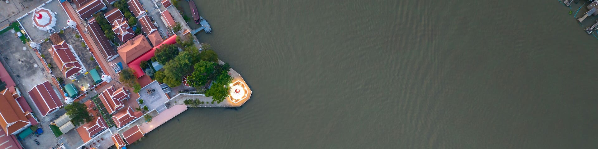 Aerial view of Pak Kret Lean Pagoda. Mon stupa rim Chao Phraya River or pagoda leaning or Tilted Pagoda of Wat Paramaiyikawat Worawihan temple at Pak kret city in Nonthaburi, Thailand