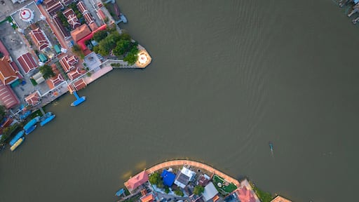Aerial view of Pak Kret Lean Pagoda. Mon stupa rim Chao Phraya River or pagoda leaning or Tilted Pagoda of Wat Paramaiyikawat Worawihan temple at Pak kret city in Nonthaburi, Thailand