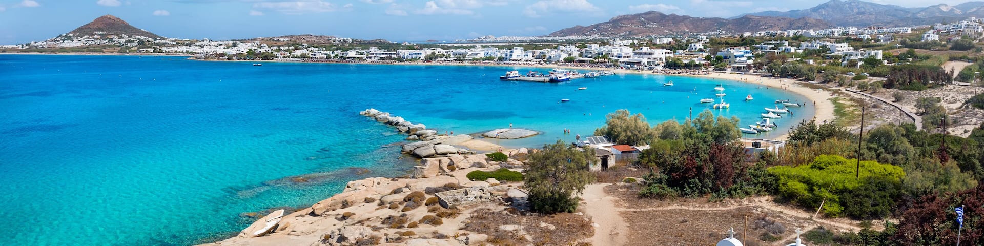 Panoramic view to the bay, beach and church of Agia Anna, Naxos island, Cyclades, Greece, with turquoise sea during summer time