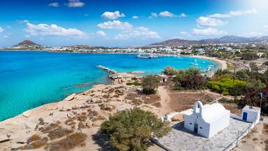 Panoramic view to the bay, beach and church of Agia Anna, Naxos island, Cyclades, Greece, with turquoise sea during summer time
