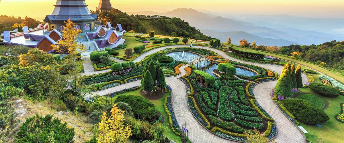 A temple complex with tiered pagodas and a well-maintained garden with winding paths and a pond.