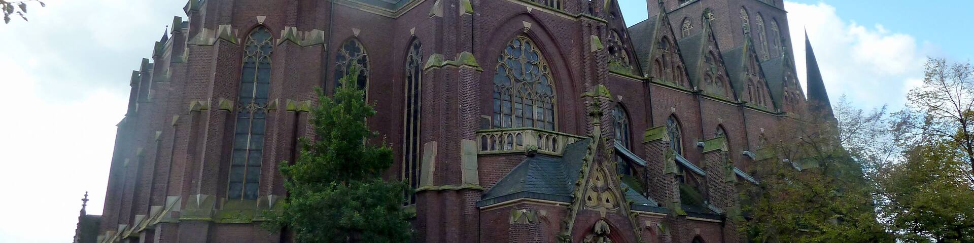 A historic church with multiple spires and a large clock tower.