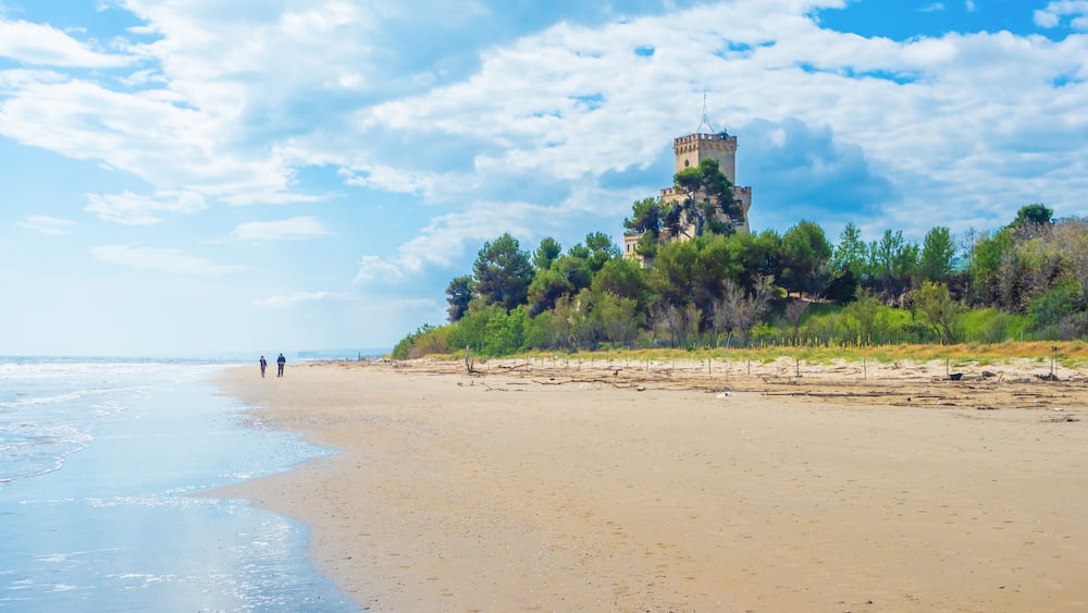 Pineto (Italy) - The touristic sandy beach of Abruzzo with the monumental pine forest and the famous tower castle called Torre di Cerrano