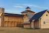 courtyard of an ancient reconstructed wooden fortress with high walls and a tower