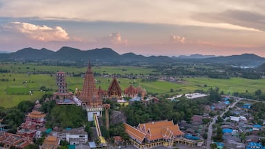 Golden Buddha statue decorated with mosaic inside the semi-circular dome. situated in outdoor area of Wat Tham Sua(Tiger Cave Temple),Tha Muang District,Kanchanaburi,Thailand.