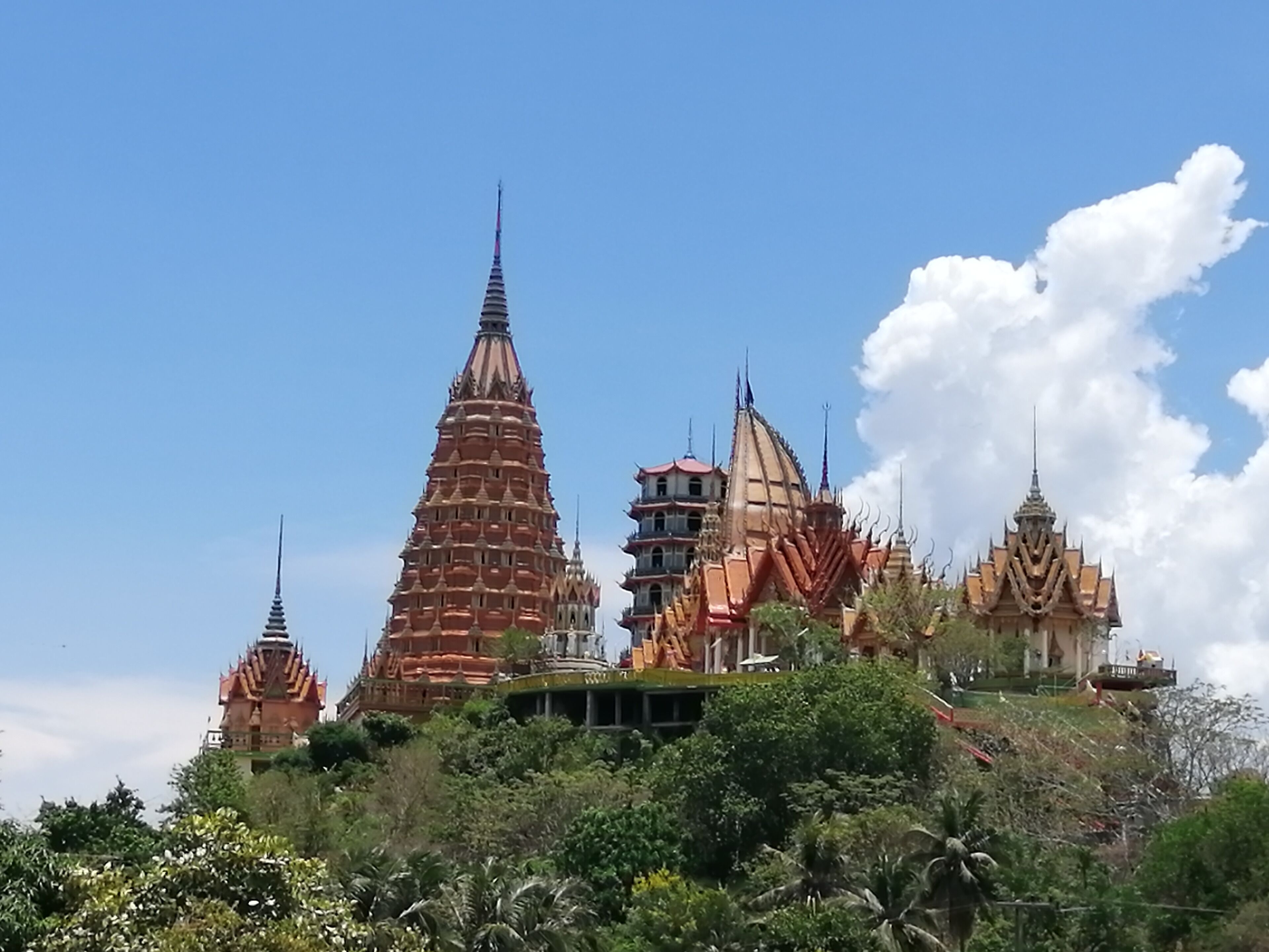 Wat Tham Suea sits on top of a hill surrounded by rice fields overlooking the River Kwai. We rented a motorbike for the day and drive out here from our guesthouse. It was well worth the drive. There are beautiful paintings, a giant Buddha, and gorgeous views.