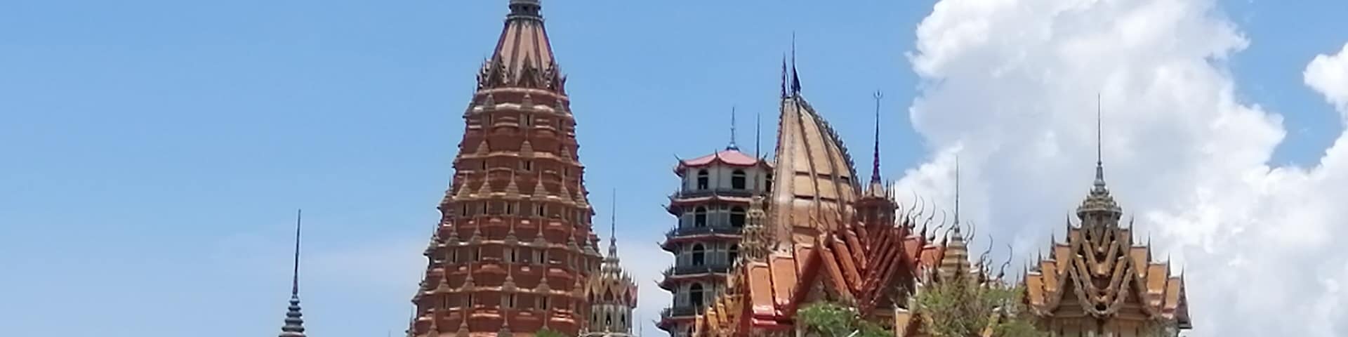 Wat Tham Suea sits on top of a hill surrounded by rice fields overlooking the River Kwai. We rented a motorbike for the day and drive out here from our guesthouse. It was well worth the drive. There are beautiful paintings, a giant Buddha, and gorgeous views.