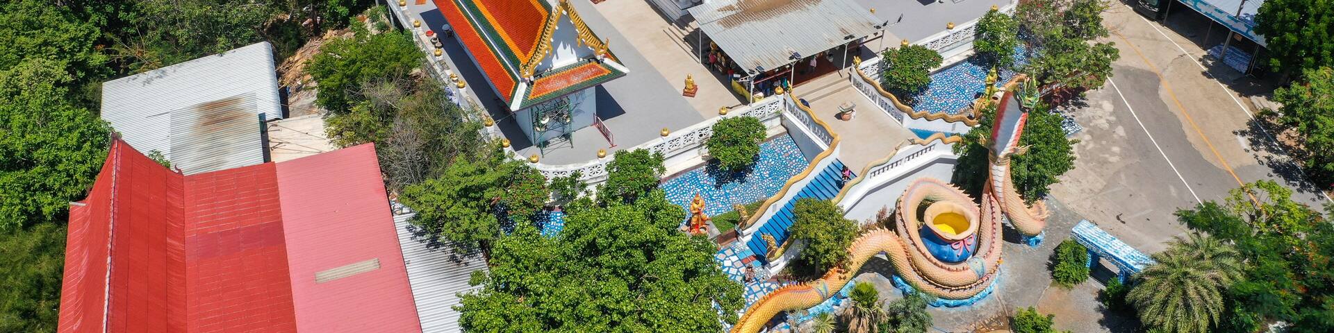 Wat Khao Sung Chaem Fa temple with giant snake and reclining gold buddha, in Kanchanaburi, Thailand