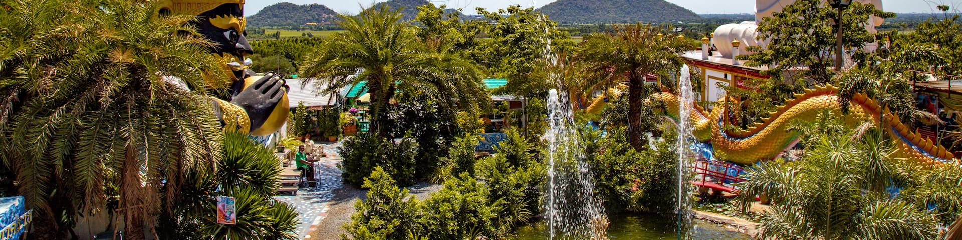 Wat Khao Sung Chaem Fa temple with giant snake and reclining gold buddha, in Kanchanaburi, Thailand