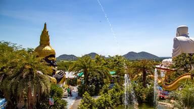 Wat Khao Sung Chaem Fa temple with giant snake and reclining gold buddha, in Kanchanaburi, Thailand