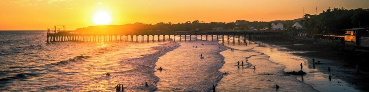 The sun setting behind the pier of La Libertad, in El Salvador.