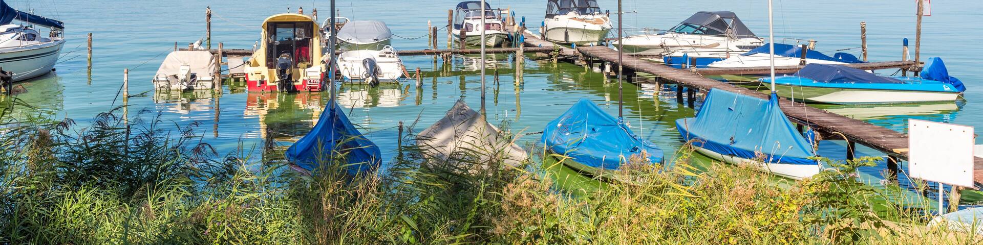Pleasure- and sail boats moored at the pier on the Schwielowsee, a lake in the state of Brandenburg, Germany