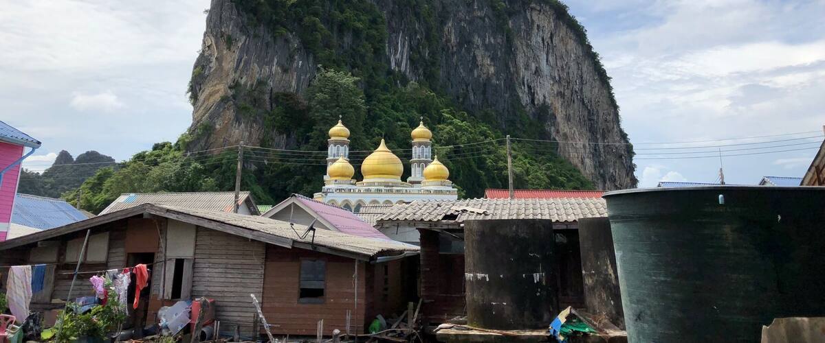 A mountain with a temple in the background.