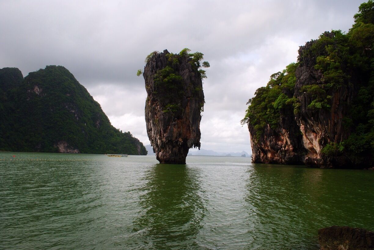 The Ko Tapu in the Ao Phang Nga Marine National Park. Most photographed and wildly popular, it is also called the James Bond Island after it appeared in "The Man with the Golden Gun".

It seems close enough to touch, 40 mts from the tiny beach, but no boats are allowed to approach it. I thought it one of the most scenic parts of the National Park. 