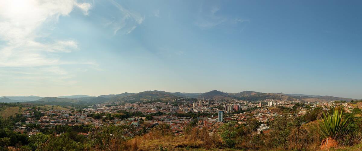 A cityscape with mountains in the background and a clear sky.