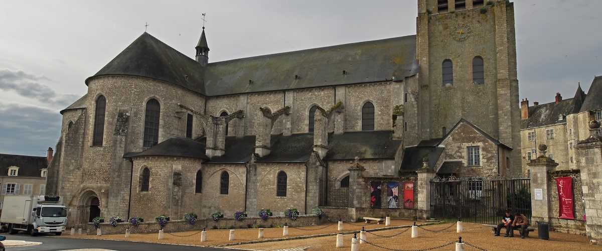 A historic church with a tall bell tower and arched windows.
