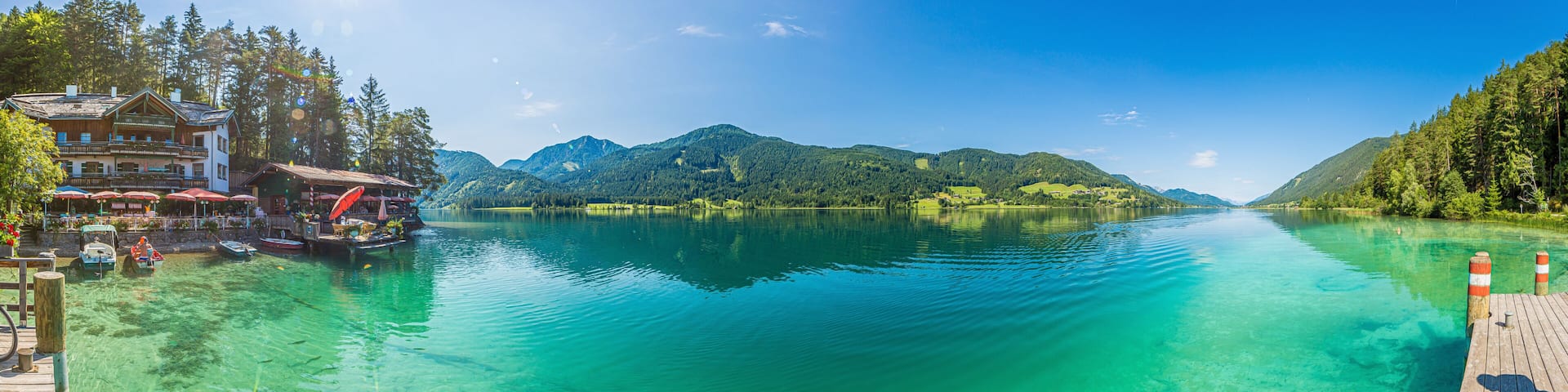 Panoramic picture over Weissensee lake in Austria with turquoise water from view point Ronacher Fels in summer