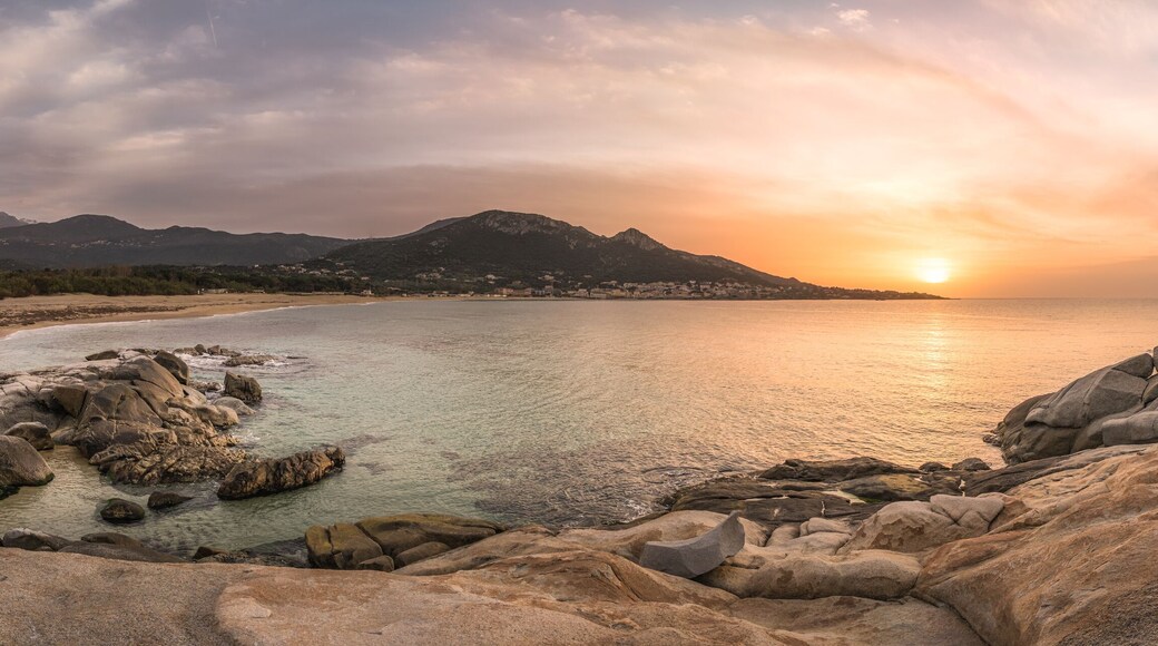Sunset over beach and village of Algajola in Corsica