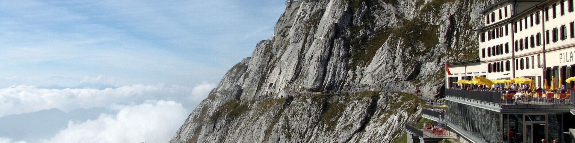 Mount Pilatus near Lucerne, Switzerland. Day trips are available from Lucerne that start with a scenic boat ride across Lake Lucerne followed by a trip to the top of Mount Pilatus via a cogwheel railway. The mountain offers many other options for recreation and scenery including gondola rides to the bottom, hiking trails atop the summit, and an aerial obstacle park in the treetops.