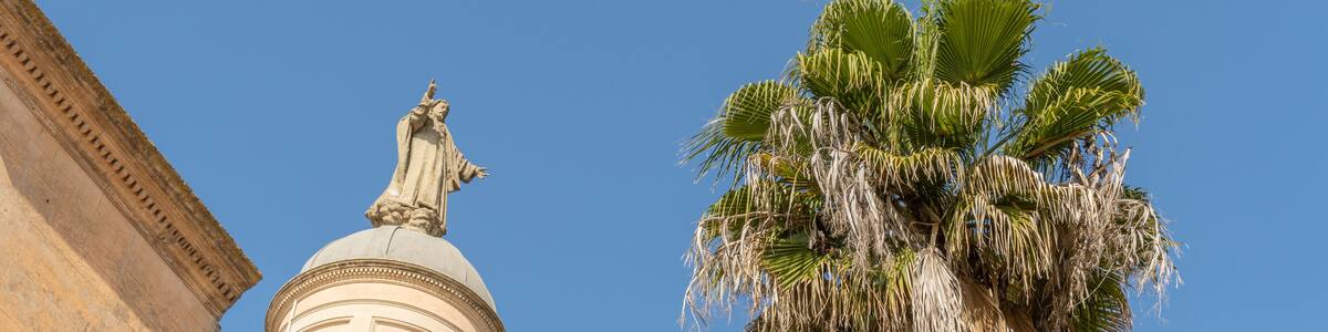 Sculpture of the Sacred Heart crowning a dome