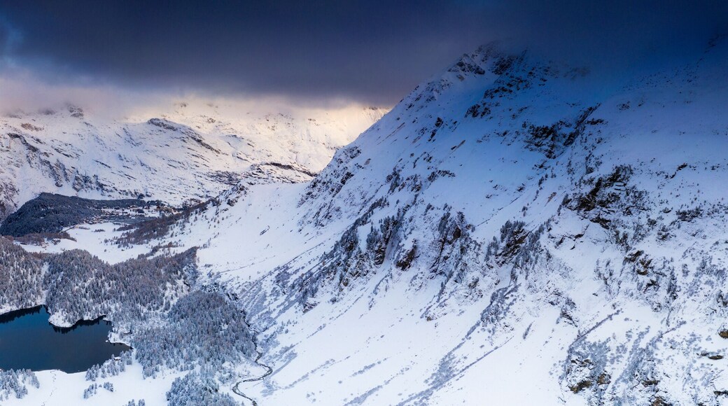 Aerial panoramic of Lake Cavloc and snowy woods, Bregaglia Valley, Engadine, canton of Graubunden, Switzerland