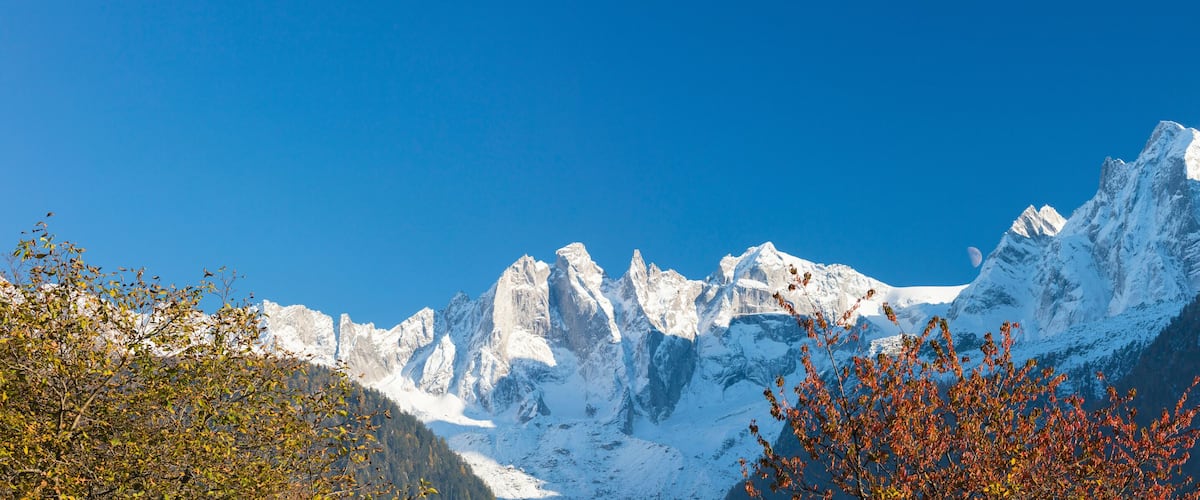 Snow-covered mountain peaks under a clear blue sky.