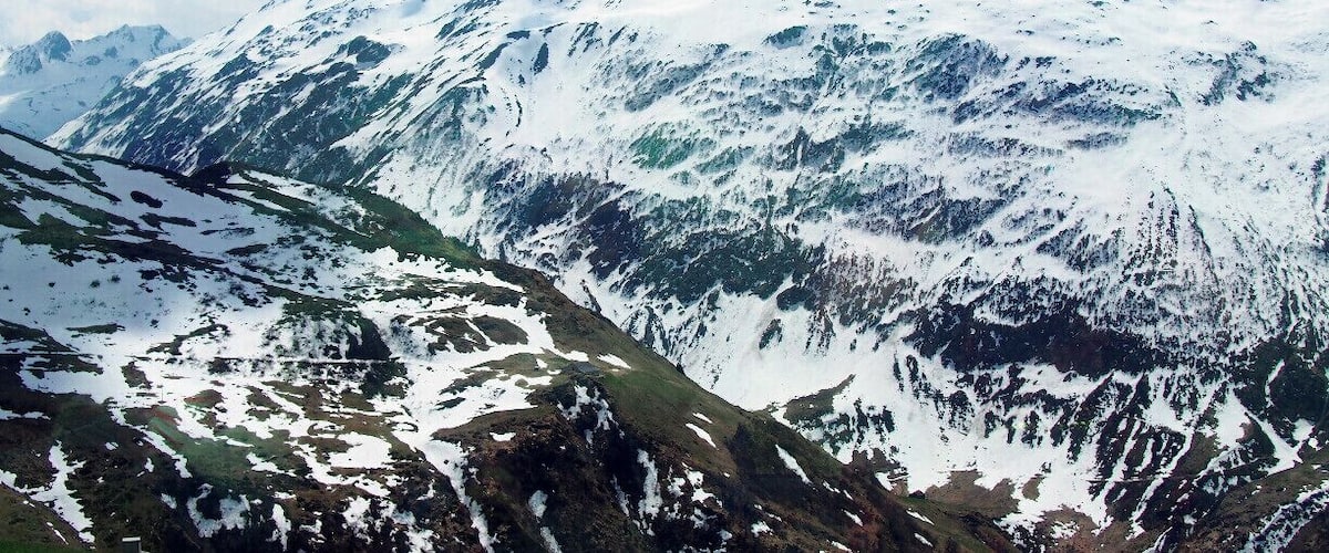A photo of the Swiss Alps snapped from the Glacier Express, a train that starts in St. Moritz and winds through the Swiss Alps until it reaches the small skiing village of Zermatt. The GA is an all-day affair. The train moves slowly so that you have plenty of time to enjoy the views, and you're served a three-course lunch at your seat. #TroverDetour