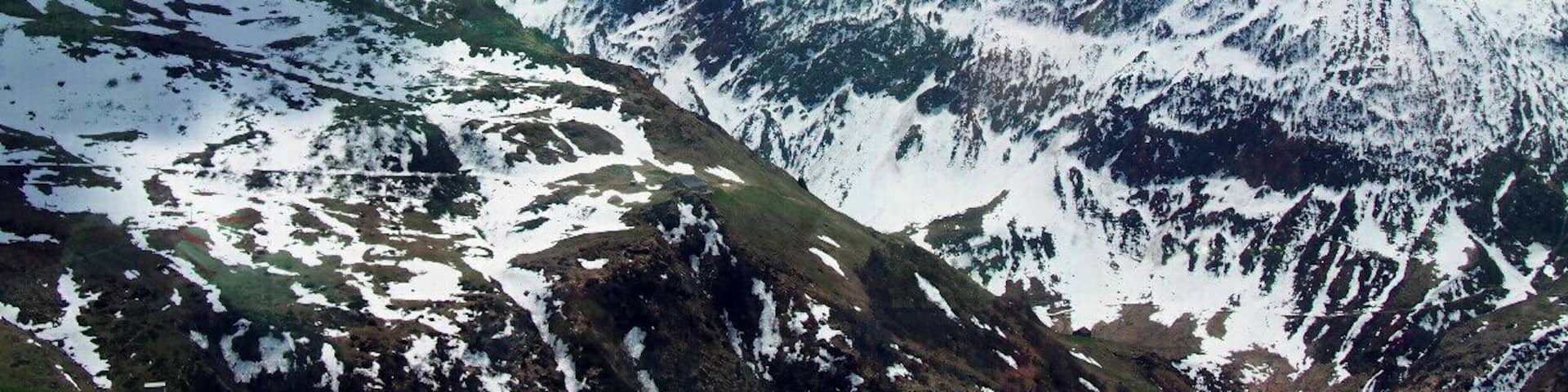 A snow-covered mountain range with clear skies.