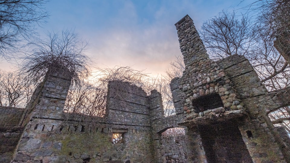 A historic stone ruin with arched doorways and a tall tower.