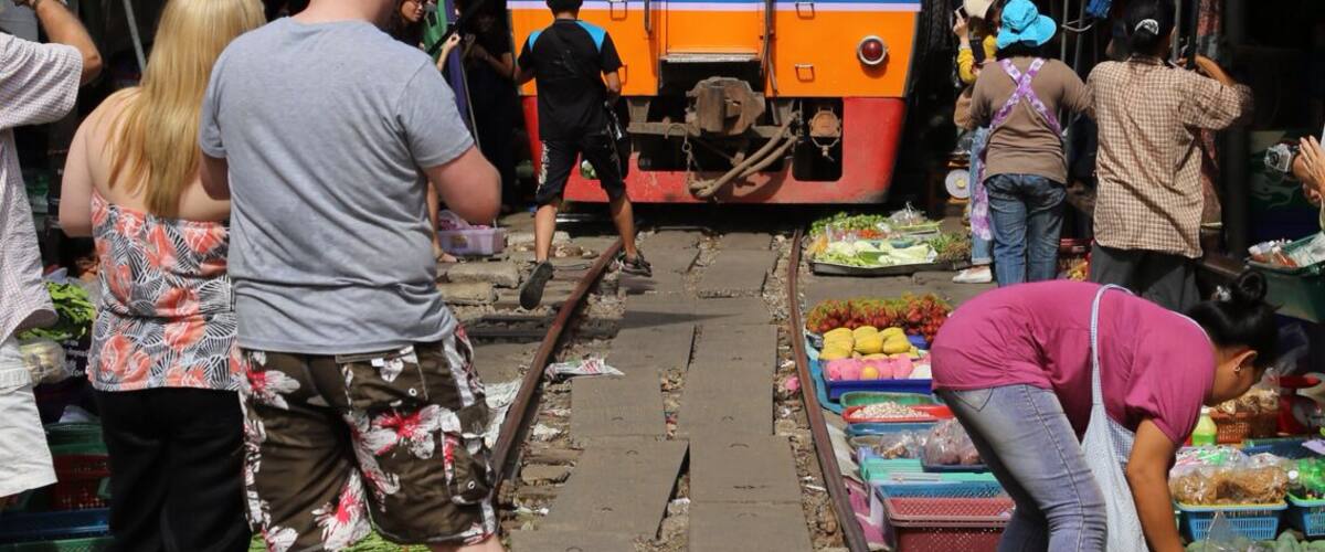 The train pass through the market four times a day! This area is near Bangkok, Thailand