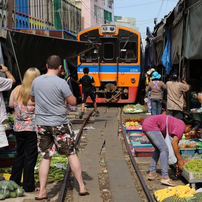 The train pass through the market four times a day! This area is near Bangkok, Thailand