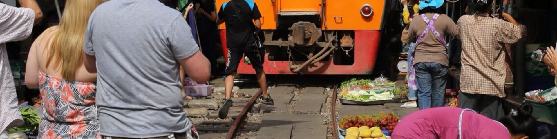The train pass through the market four times a day! This area is near Bangkok, Thailand