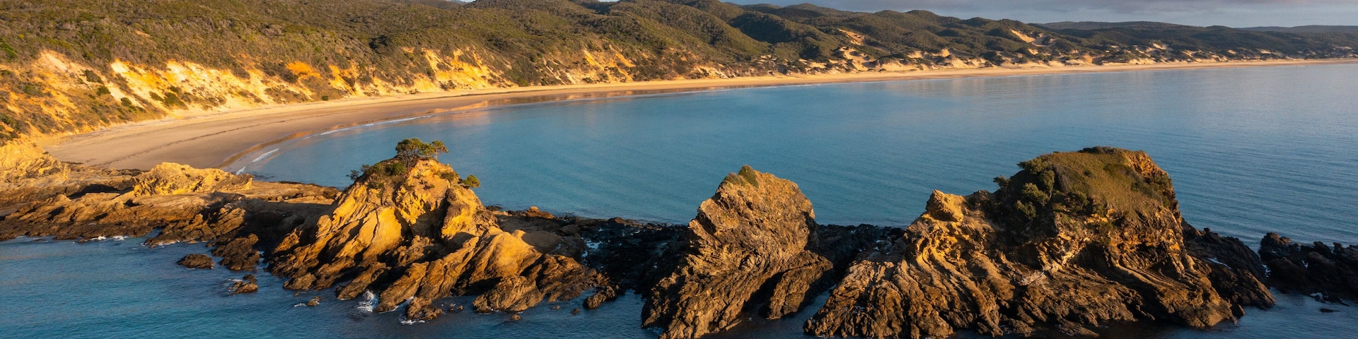 Byfield featuring rugged coastline, general coastal views and a sunset