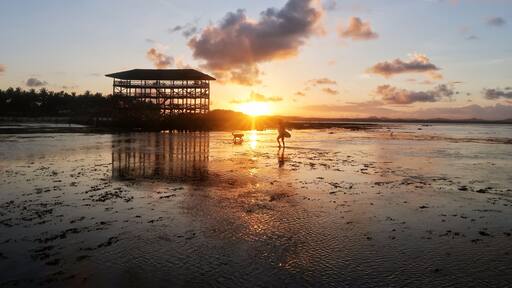 Stunning sunset at the iconic boardwalk @ Cloud 9 surfing spot in Siargao, the capital of surfing of the Philippines