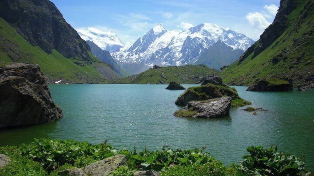A lake surrounded by mountains with snow-capped peaks.