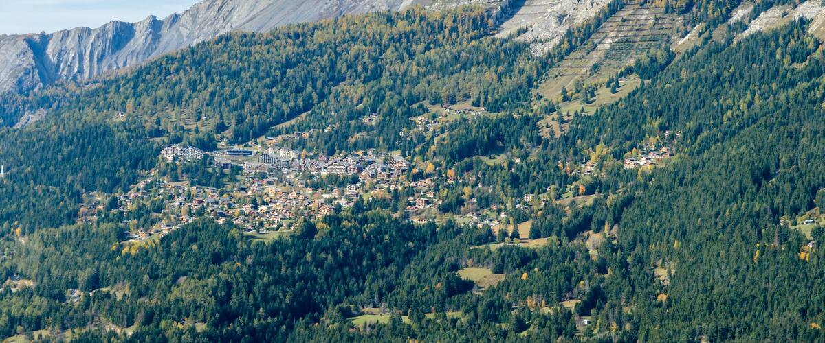 A mountainous landscape with a town nestled among the hills.