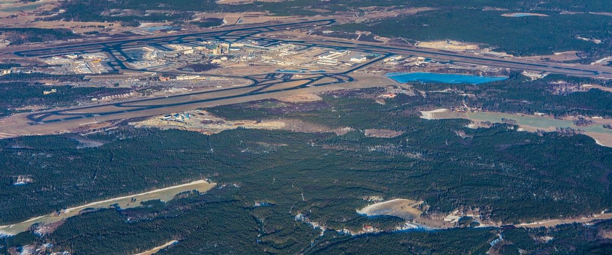 An aerial view of a large industrial complex with multiple roads and a river.