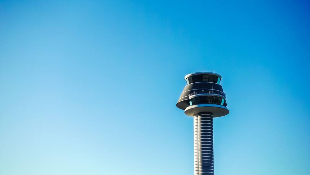 Modern high tech air traffic control tower of Arlanda airport in Sweden with blue sky background copy space as travel, tourism and transport concept