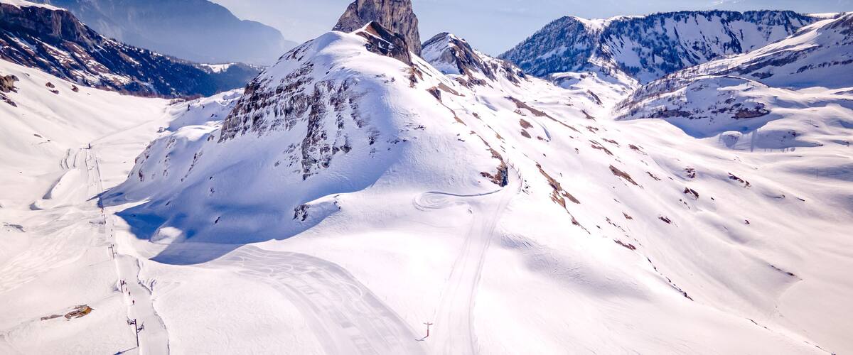 A snow-covered mountain peak with a clear sky.
