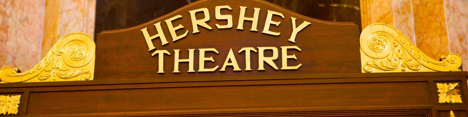 A sign for Hershey Theatre with ornate gold detailing.