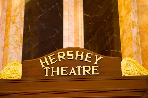 A sign for Hershey Theatre with ornate gold detailing.