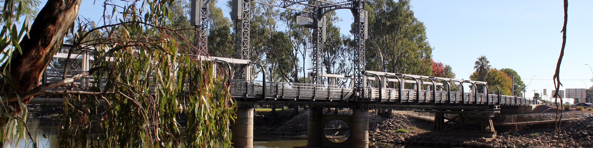 The Koondrook-Barham Bridge crossing the Murray River with a eucalyptus tree in the foreground on the border of New South Wales and Victoria in Australia