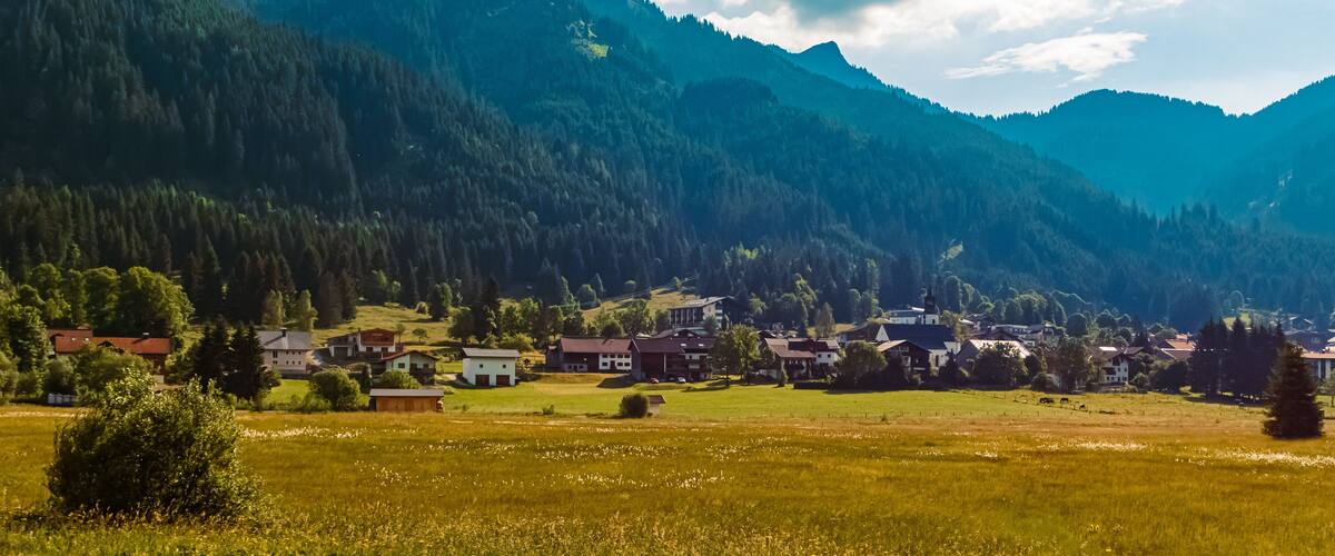 A mountainous landscape with a village nestled in a valley.