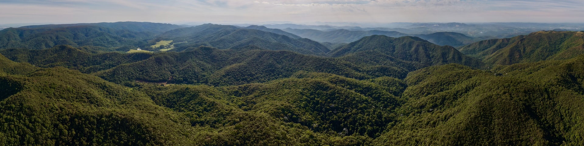 Misty morning landscape with fog over green hills in Cabreuva, Brazil