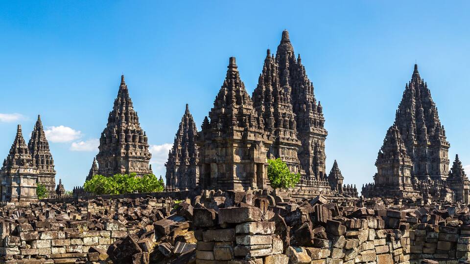 A temple complex with multiple tiered towers and ruins.