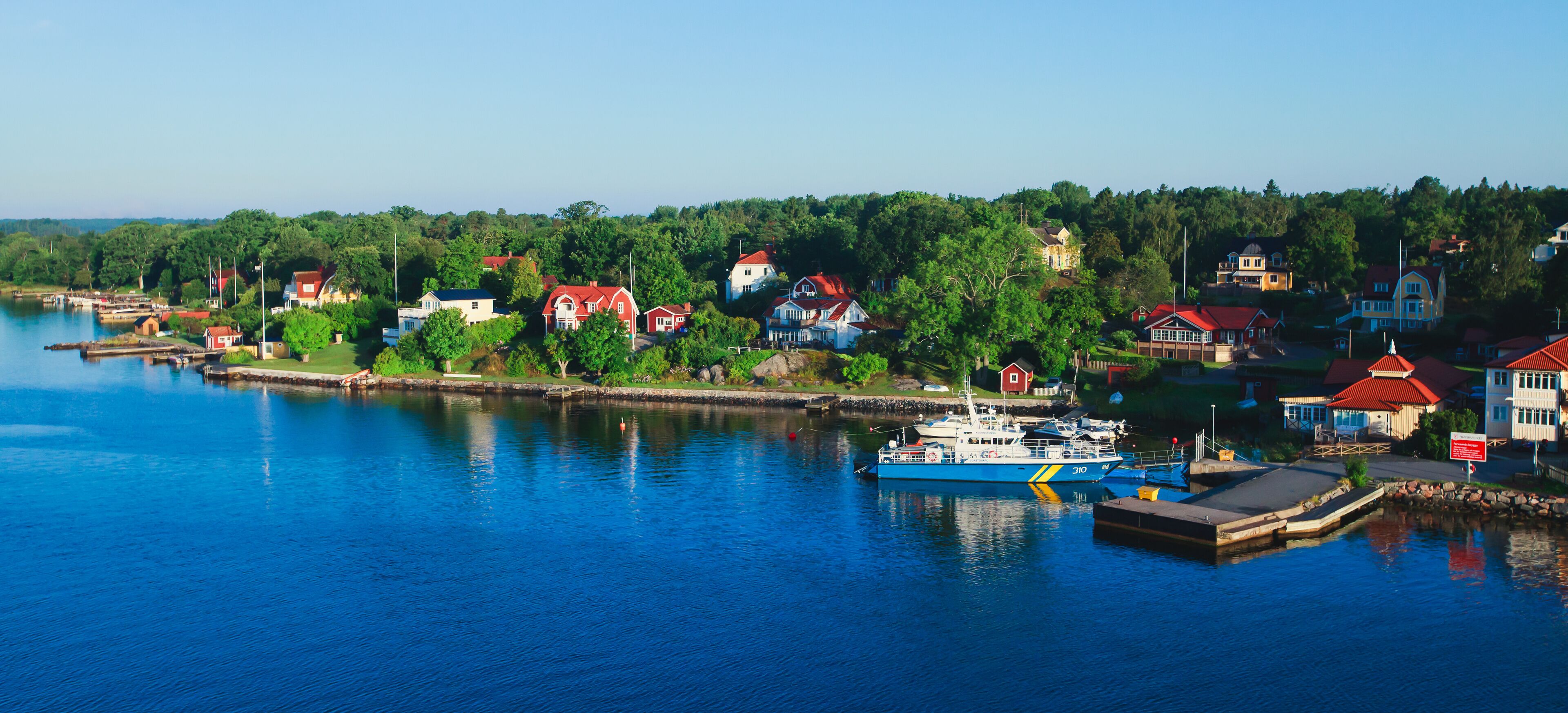 Beautiful super wide-angle panoramic aerial view of Stockholm archipelago, Sweden with harbor and skyline with scenery beyond the city, seen from the ferry, sunny summer day with blue sky